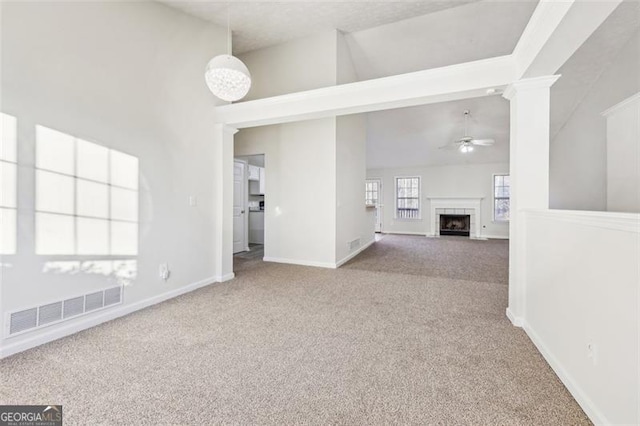 245 London Ln, Hiram, GA 30141 - unfurnished living room with carpet floors, ceiling fan, high vaulted ceiling, and a fireplace with flush hearth