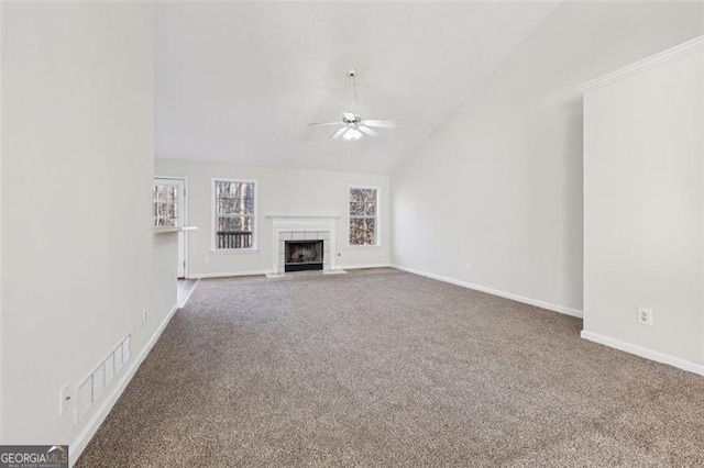 245 London Ln, Hiram, GA 30141 - unfurnished living room with ceiling fan, carpet flooring, vaulted ceiling, and a tile fireplace