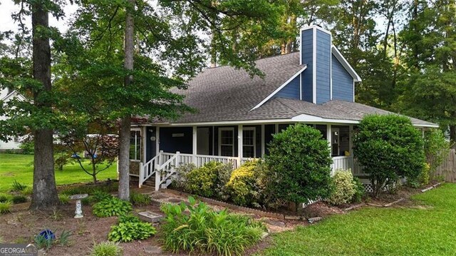 233 Oakridge Dr, Cartersville, GA 30121 - view of front of home with a chimney, roof with shingles, covered porch, and a front lawn