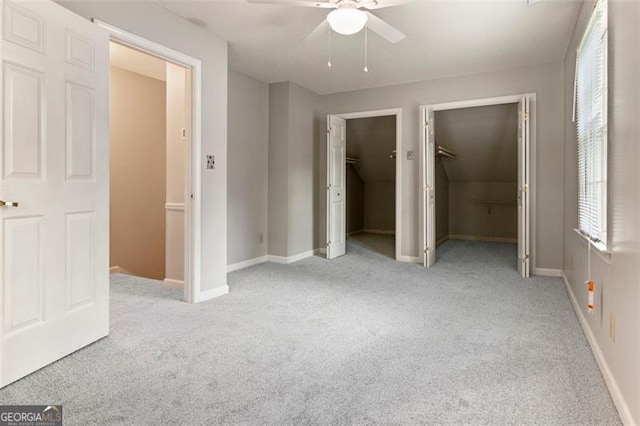 233 Oakridge Dr, Cartersville, GA 30121 - unfurnished bedroom with light carpet, multiple closets, ceiling fan, and baseboards