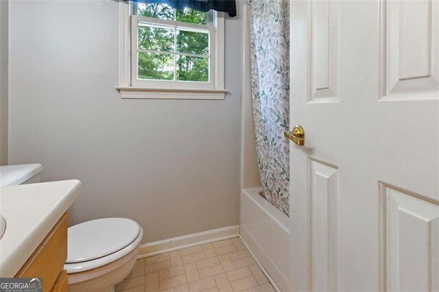 233 Oakridge Dr, Cartersville, GA 30121 - bathroom featuring vanity, toilet, baseboards, shower / tub combo with curtain, and tile patterned floors