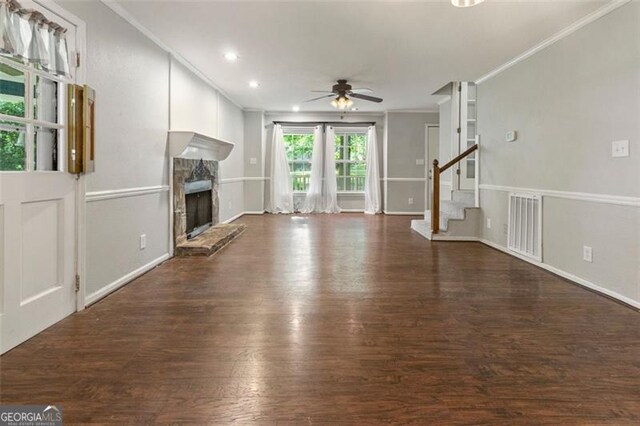 233 Oakridge Dr, Cartersville, GA 30121 - unfurnished living room with a fireplace, a ceiling fan, ornamental molding, wood finished floors, and stairs