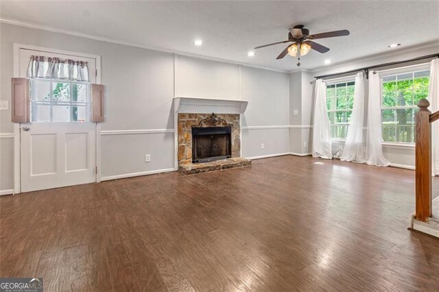 233 Oakridge Dr, Cartersville, GA 30121 - unfurnished living room featuring crown molding, a ceiling fan, wood finished floors, a stone fireplace, and recessed lighting