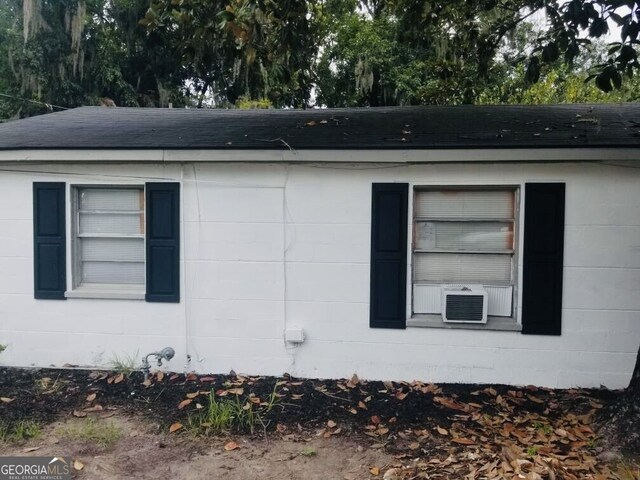 2214 Shell Rd, Savannah, GA 31404 - view of property exterior with concrete block siding, roof with shingles, and cooling unit