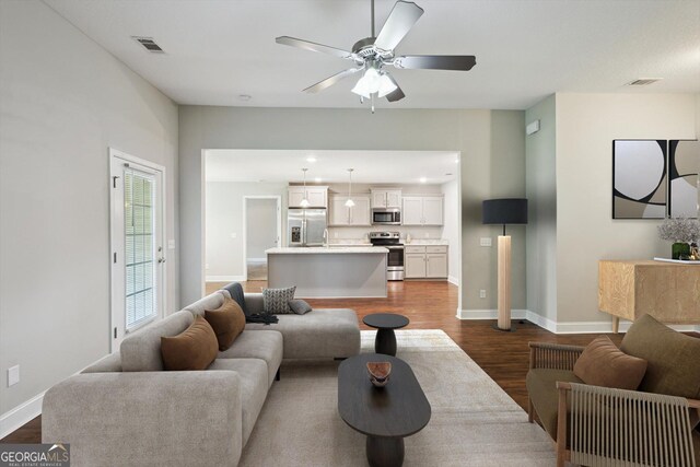 178 Stonebrook Way, Statesboro, GA 30458 - living area with dark wood finished floors, a ceiling fan, and baseboards
