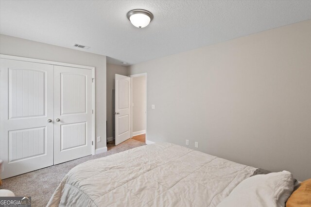 178 Stonebrook Way, Statesboro, GA 30458 - bedroom with a closet, carpet floors, baseboards, and a textured ceiling