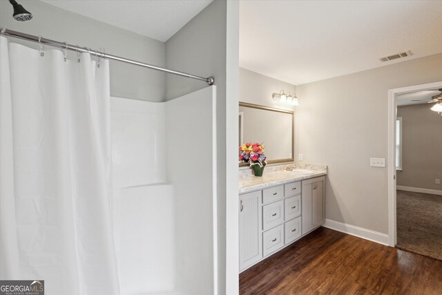178 Stonebrook Way, Statesboro, GA 30458 - full bathroom featuring wood finished floors, double vanity, baseboards, curtained shower, and a ceiling fan