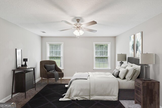 178 Stonebrook Way, Statesboro, GA 30458 - bedroom featuring multiple windows, dark colored carpet, baseboards, a ceiling fan, and a textured ceiling