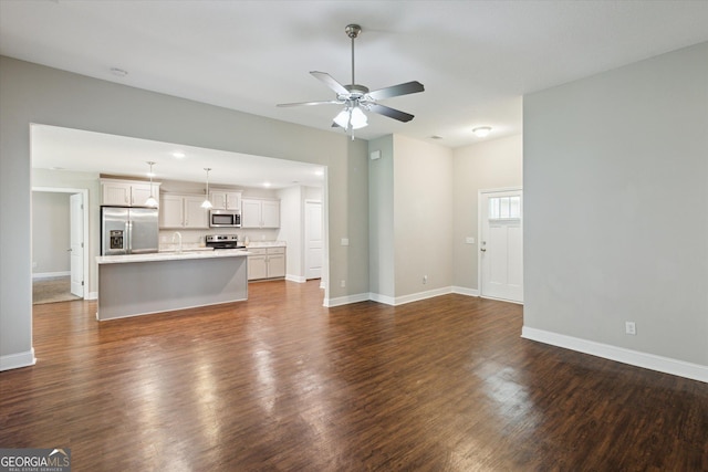 178 Stonebrook Way, Statesboro, GA 30458 - unfurnished living room with a ceiling fan, dark wood-type flooring, a sink, and baseboards