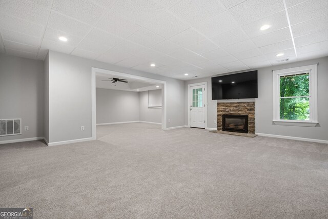 1010 Longcreek Pointe Pointe, Alpharetta, GA 30005 - unfurnished living room with carpet flooring, baseboards, a stone fireplace, a drop ceiling, and recessed lighting