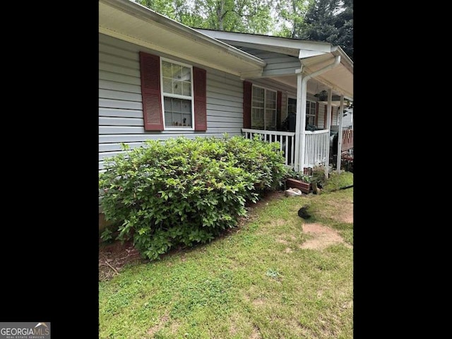 6305 Eidson Dr, Cumming, GA 30041 - view of property exterior with a porch and a yard