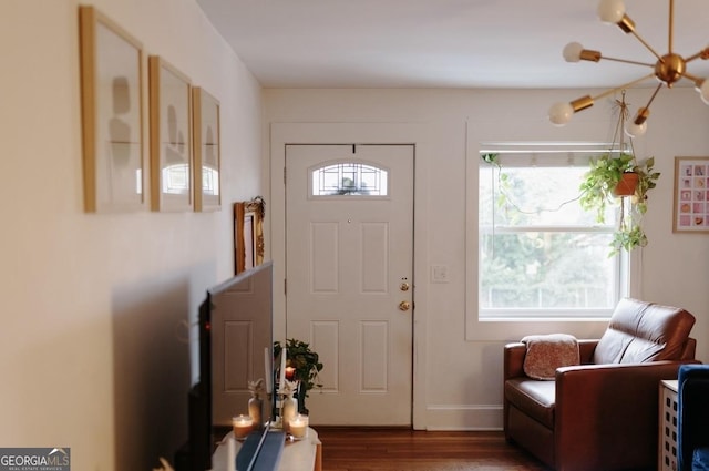 351 Cherokee Ave SE Apt 10, Atlanta, GA 30312 - foyer featuring wood finished floors, a chandelier, and baseboards