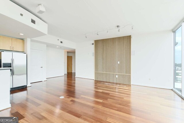 361 17th St NW Unit 1702, Atlanta, GA 30363 - unfurnished living room featuring light wood-style flooring and rail lighting