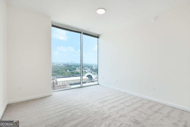 361 17th St NW Unit 1702, Atlanta, GA 30363 - spare room featuring floor to ceiling windows, carpet, and baseboards