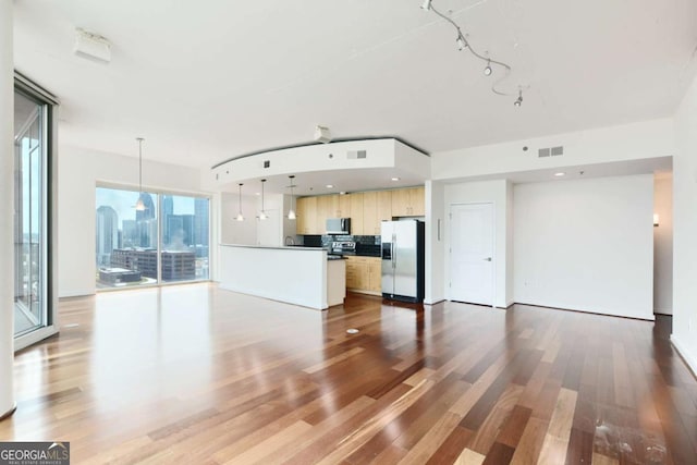 361 17th St NW Unit 1702, Atlanta, GA 30363 - kitchen with appliances with stainless steel finishes, open floor plan, and wood finished floors