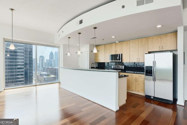 361 17th St NW Unit 1702, Atlanta, GA 30363 - kitchen with stainless steel appliances, light brown cabinets, dark wood finished floors, and recessed lighting