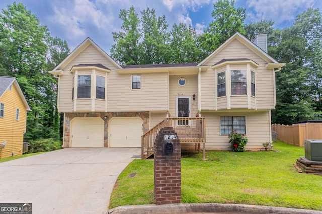 1214 Tyne Way, Stone Mountain, GA 30088 - split foyer home featuring concrete driveway, an attached garage, and a chimney