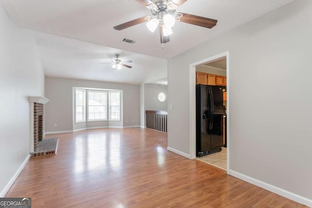 1214 Tyne Way, Stone Mountain, GA 30088 - unfurnished living room with ceiling fan, light wood-style floors, and baseboards