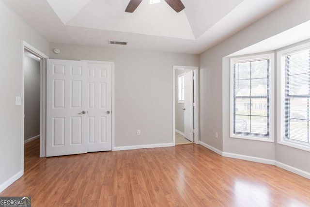 1214 Tyne Way, Stone Mountain, GA 30088 - unfurnished bedroom featuring light wood-type flooring, multiple windows, baseboards, lofted ceiling, and a ceiling fan