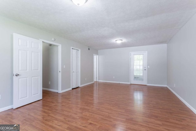 1214 Tyne Way, Stone Mountain, GA 30088 - spare room featuring wood finished floors, a textured ceiling, and baseboards