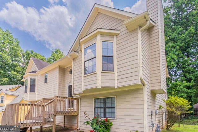 1214 Tyne Way, Stone Mountain, GA 30088 - back of property featuring a deck, a chimney, and stairway