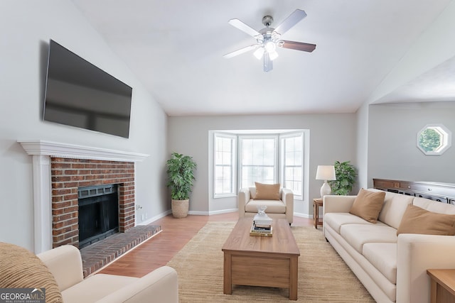 1214 Tyne Way, Stone Mountain, GA 30088 - living area featuring vaulted ceiling, a ceiling fan, light wood-style flooring, a fireplace, and baseboards