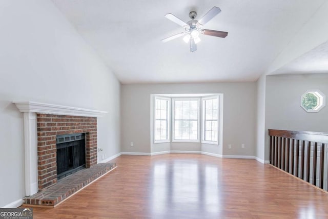 1214 Tyne Way, Stone Mountain, GA 30088 - unfurnished living room with ceiling fan, wood finished floors, lofted ceiling, a fireplace, and baseboards