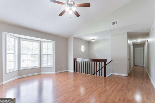 1214 Tyne Way, Stone Mountain, GA 30088 - empty room featuring wood finished floors, baseboards, a ceiling fan, and high vaulted ceiling