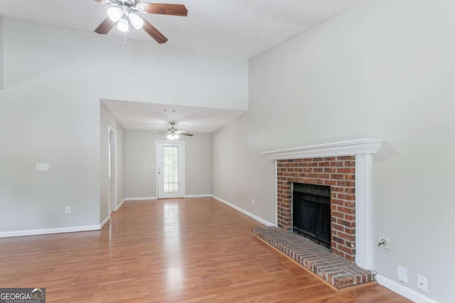 1214 Tyne Way, Stone Mountain, GA 30088 - unfurnished living room featuring a ceiling fan, a fireplace, wood finished floors, and baseboards