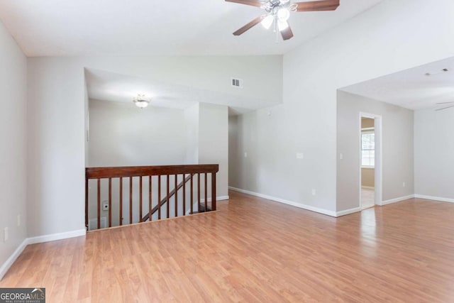 1214 Tyne Way, Stone Mountain, GA 30088 - spare room with ceiling fan, lofted ceiling, light wood finished floors, and baseboards