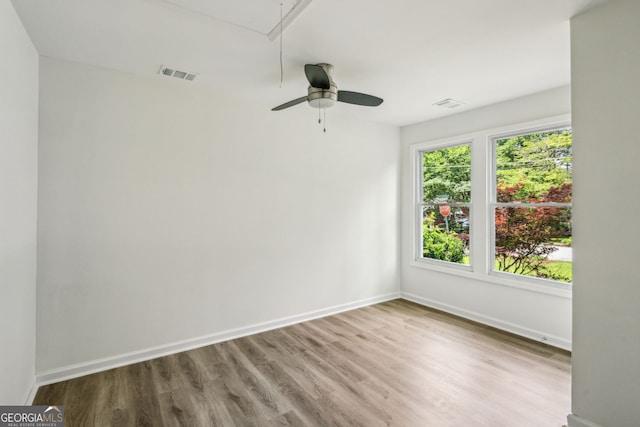 2485 Hillside Ave, Decatur, GA 30032 - spare room featuring attic access, wood finished floors, baseboards, and a ceiling fan