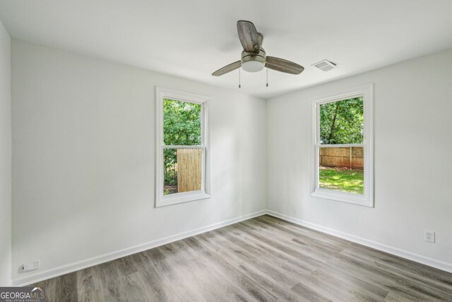 2485 Hillside Ave, Decatur, GA 30032 - unfurnished room with wood finished floors, healthy amount of natural light, and baseboards