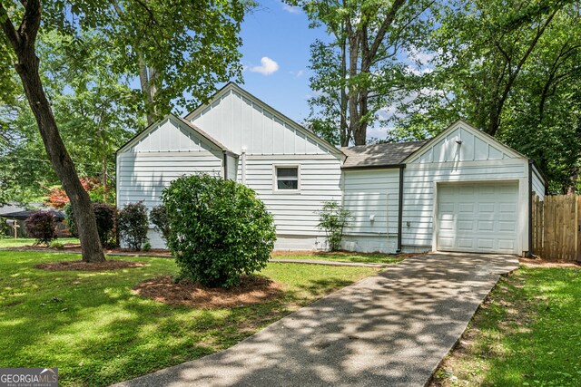 2485 Hillside Ave, Decatur, GA 30032 - view of side of home featuring board and batten siding, a garage, concrete driveway, and roof with shingles