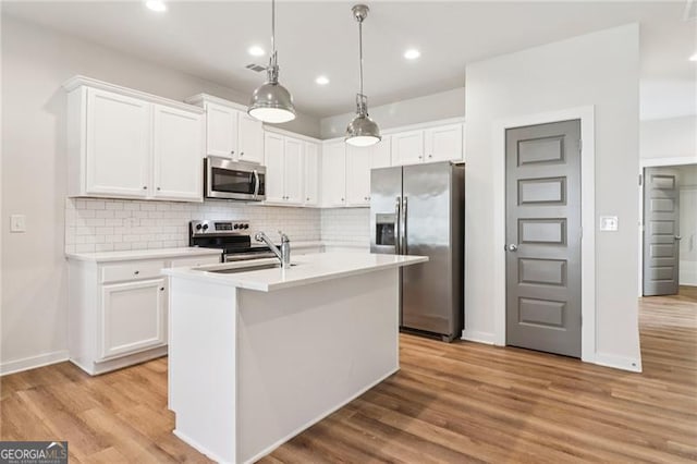 480 Oconner Blvd, Athens, GA 30607 - kitchen featuring stainless steel appliances, white cabinetry, decorative backsplash, light wood-type flooring, and recessed lighting