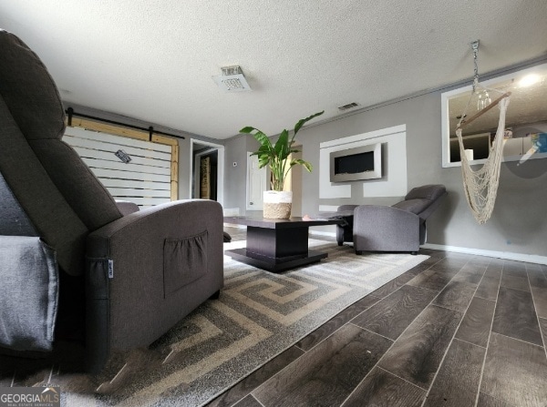 617 Willard Ave, Albany, GA 31701 - living room featuring wood finish floors, a textured ceiling, and a barn door
