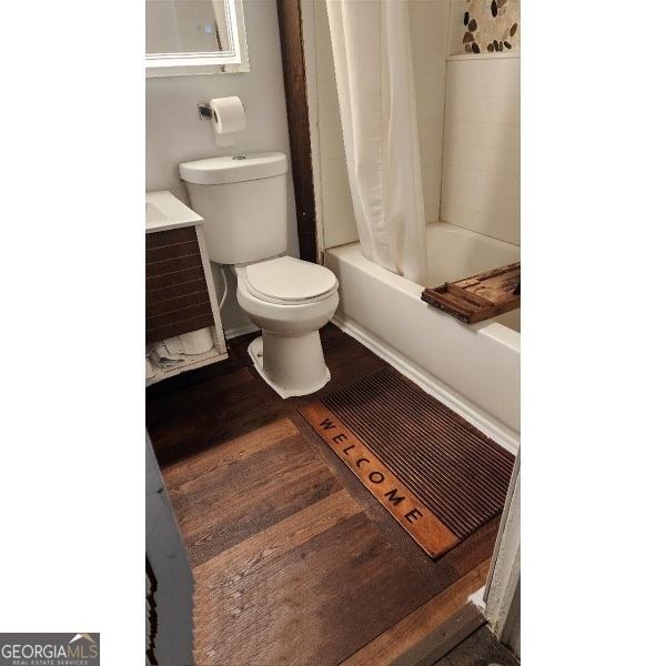 617 Willard Ave, Albany, GA 31701 - full bath featuring shower / bathtub combination with curtain, vanity, and wood finished floors