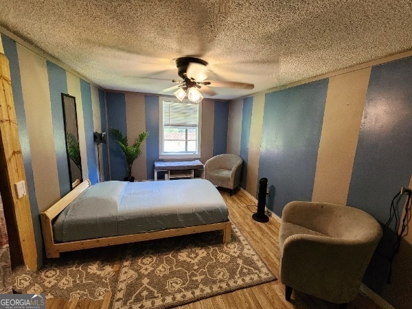 617 Willard Ave, Albany, GA 31701 - bedroom with wood finished floors, a textured ceiling, and a ceiling fan