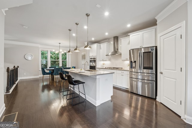 4012 Townsend Ln, Dunwoody, GA 30346 - kitchen featuring appliances with stainless steel finishes, wall chimney range hood, a center island with sink, tasteful backsplash, and recessed lighting