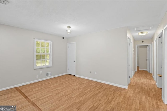 1594 Pine Glen Cir, Decatur, GA 30035 - spare room featuring light wood-style floors, attic access, and a smoke detector