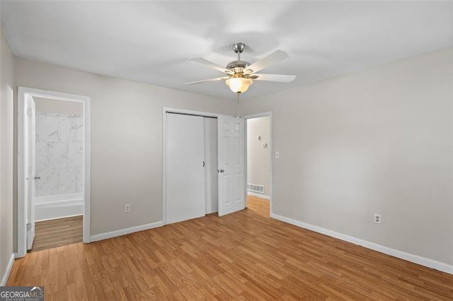 1594 Pine Glen Cir, Decatur, GA 30035 - unfurnished bedroom with wood finished floors, a closet, connected bathroom, and ceiling fan