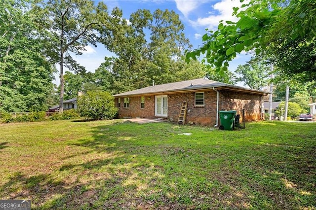 1594 Pine Glen Cir, Decatur, GA 30035 - back of property with a lawn, brick siding, and a patio