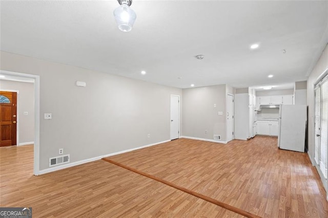 1594 Pine Glen Cir, Decatur, GA 30035 - unfurnished living room featuring light wood-type flooring and recessed lighting