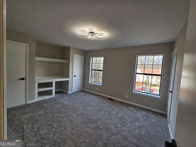 6002 Pat Mell Pl SE, Smyrna, GA 30080 - unfurnished bedroom with dark carpet and baseboards
