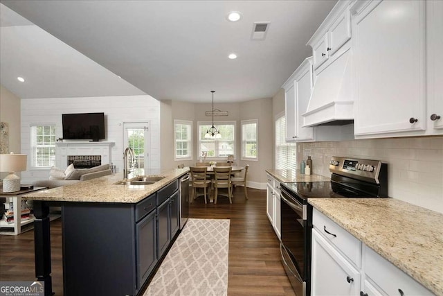 255 Solihull Ln, Athens, GA 30605 - kitchen featuring stainless steel appliances, custom range hood, a sink, white cabinetry, and a fireplace