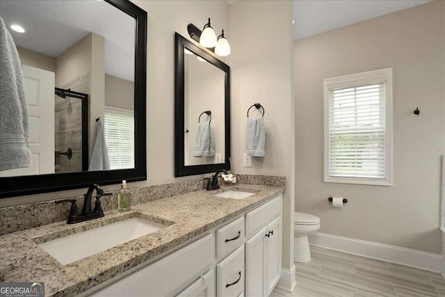 255 Solihull Ln, Athens, GA 30605 - full bathroom with healthy amount of natural light, tiled shower, double vanity, and baseboards