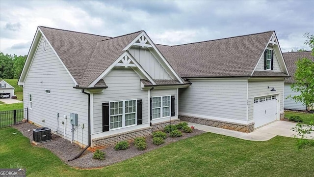 255 Solihull Ln, Athens, GA 30605 - view of front facade with concrete driveway, a shingled roof, board and batten siding, and central AC unit
