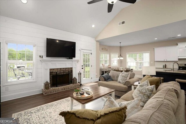 255 Solihull Ln, Athens, GA 30605 - living area with dark wood finished floors, a fireplace, ceiling fan, baseboards, and high vaulted ceiling