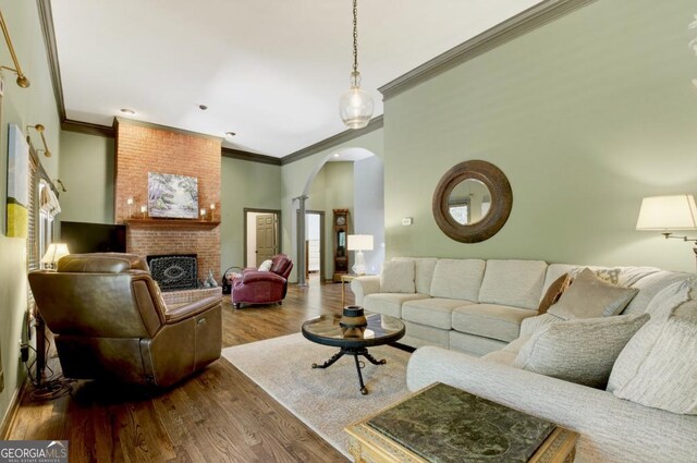 312 Sterling Rd, Jasper, GA 30143 - living area with arched walkways, ornamental molding, dark wood-style flooring, a brick fireplace, and ornate columns