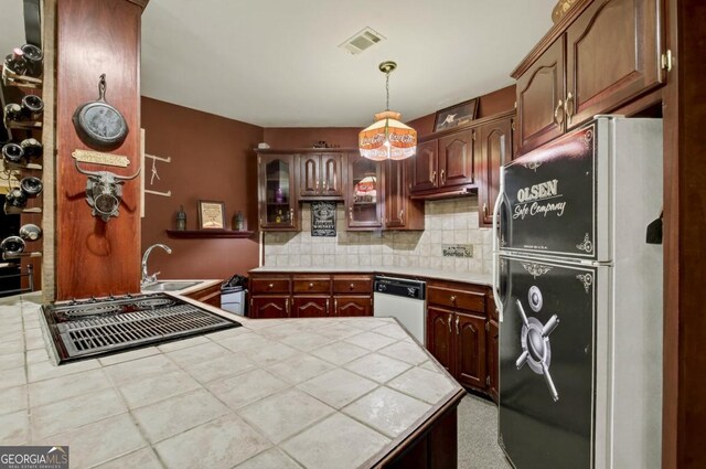 312 Sterling Rd, Jasper, GA 30143 - kitchen with white appliances, a sink, tile countertops, tasteful backsplash, and a peninsula