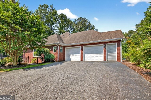 312 Sterling Rd, Jasper, GA 30143 - view of front of house featuring brick siding, asphalt driveway, a garage, and a shingled roof